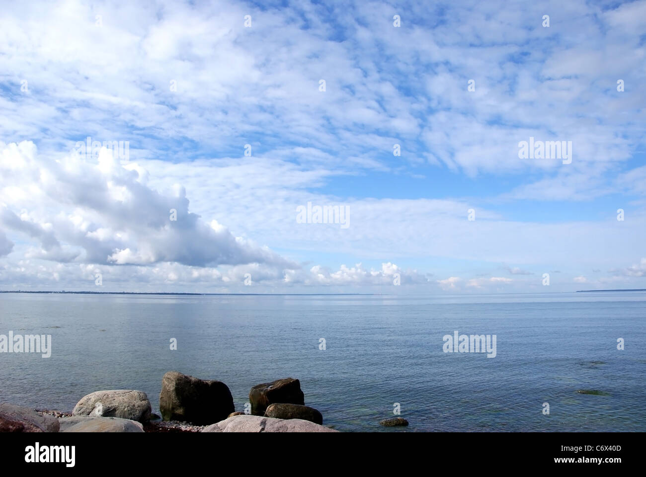 The sea on a background of the blue sky and clouds Stock Photo - Alamy