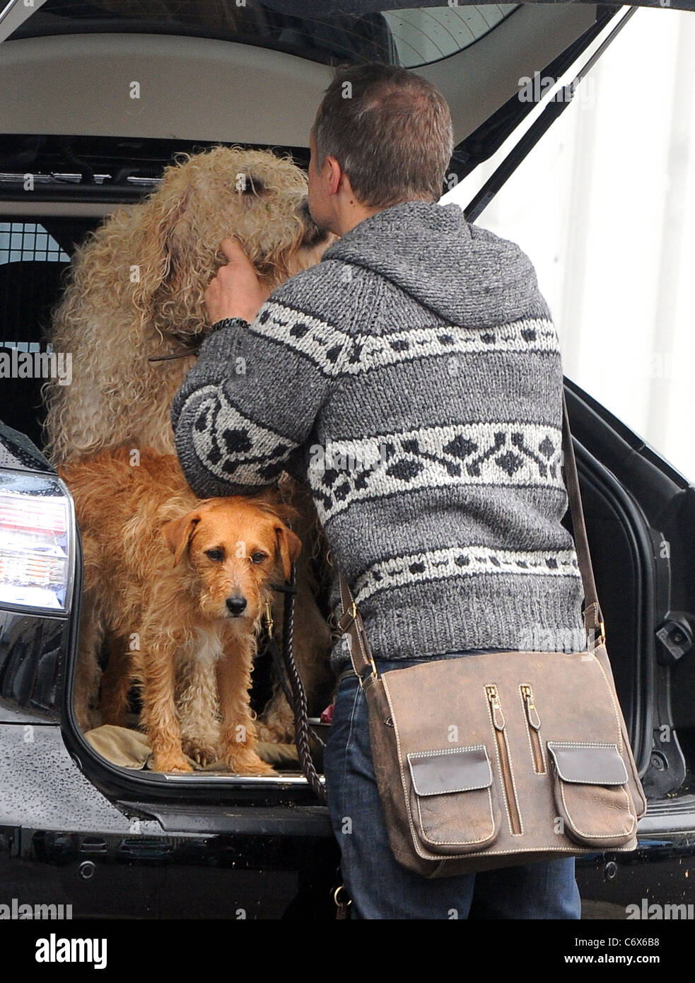 Graham Norton kisses his dog as he arrives at the Fountain Studios to