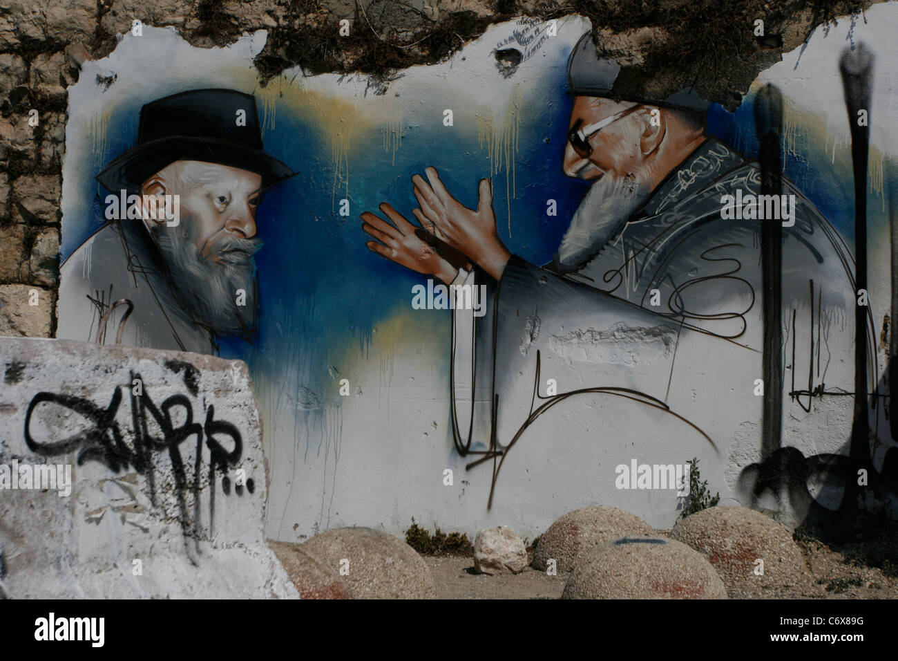 A wall painting in Hebron is showing an Jewish ultra-orthodox settler together with the prominent Chief Rabbi Yosef Ovadia Stock Photo