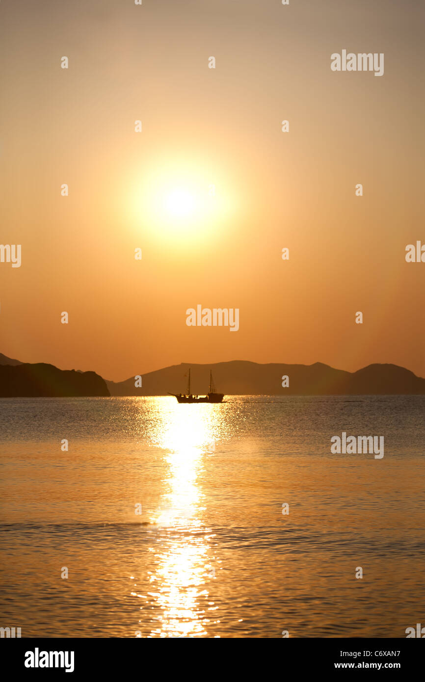 Vintage sailboat sailing in the sea at sunrise Stock Photo - Alamy