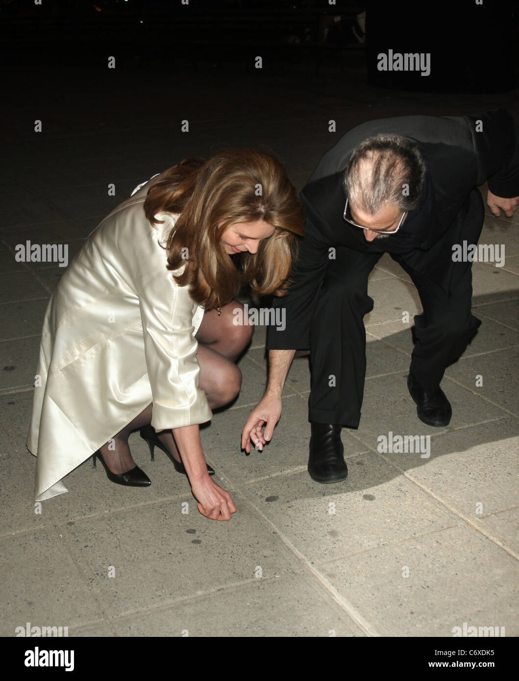 Queen Noor Of Jordan drops an earing at the Vanity Fair party before