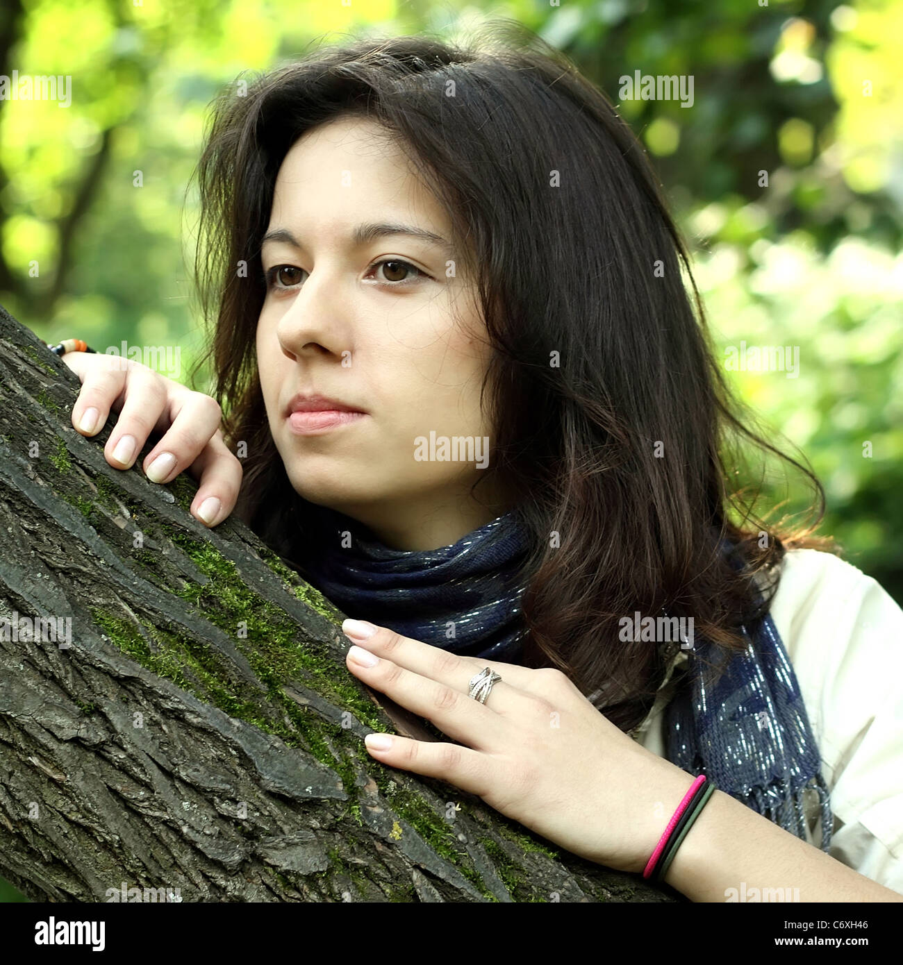Portrait Of A Beautiful Dark Haired Girl Beside A Tree Stock Photo