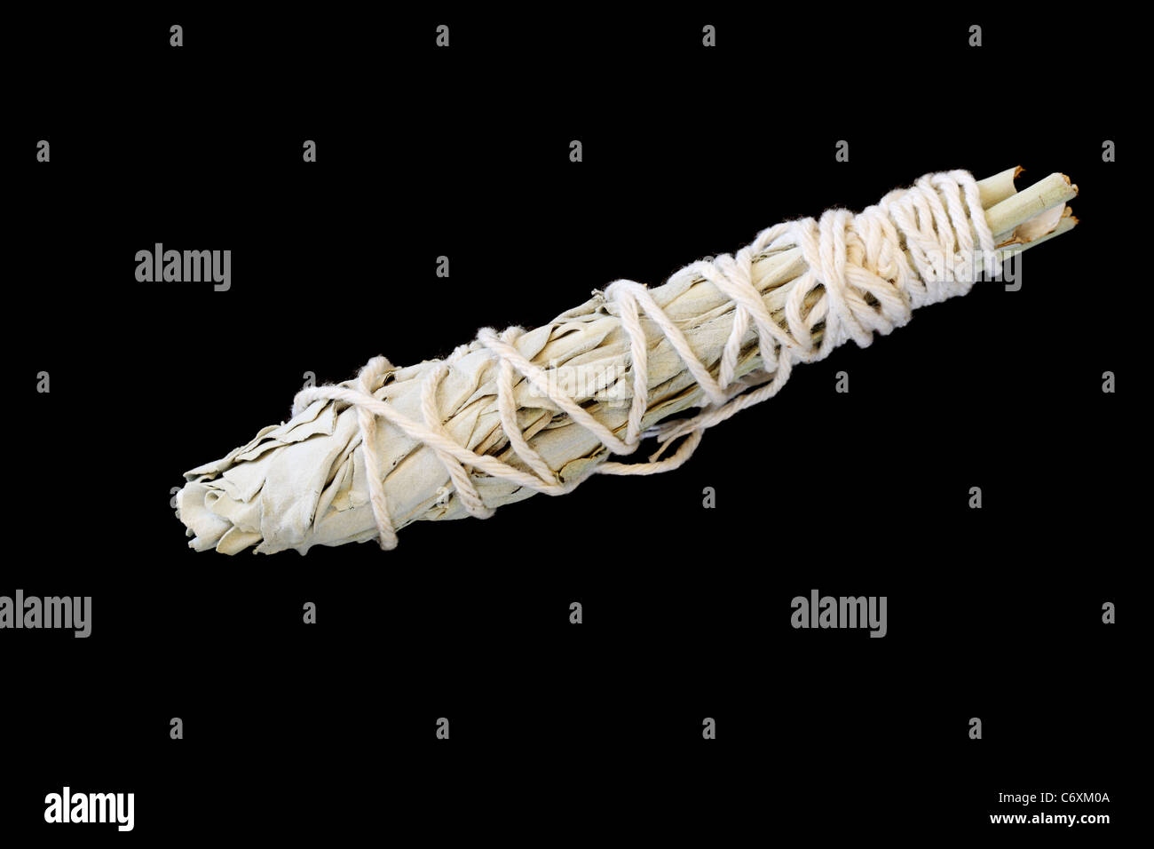 white sage ceremonial bundle wrapped with string on black background Stock Photo