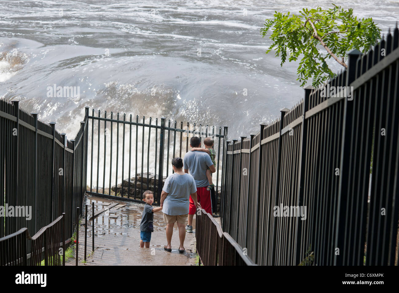 Visitors watch the thousands of gallons of water cascading over the Great Falls of the Passaic River in Paterson, NJ Stock Photo