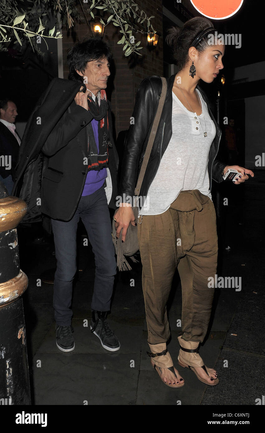 Ronnie Wood and his girlfriend Ana Araujo leaving a restaurant in Mayfair, having enjoyed dinner there together London, England Stock Photo
