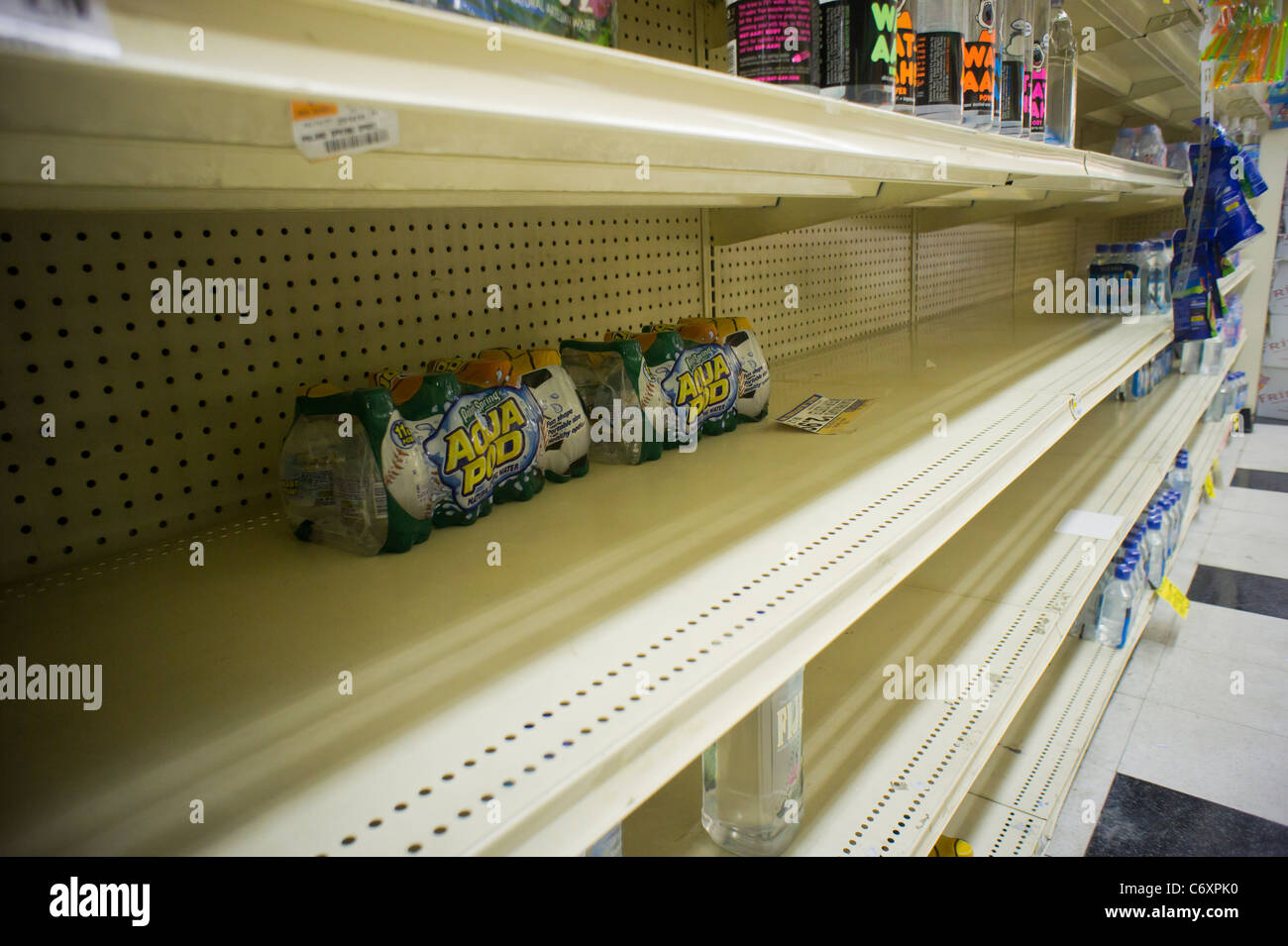 Shelves stripped bare of bottled water by customers stocking up for