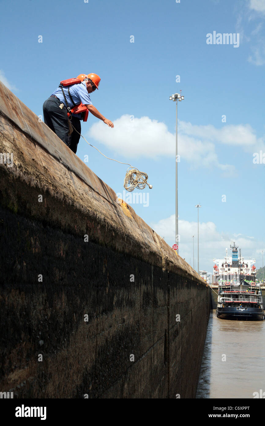 Panama Canal workers handling ship lines at the Miraflores Locks. Stock Photo