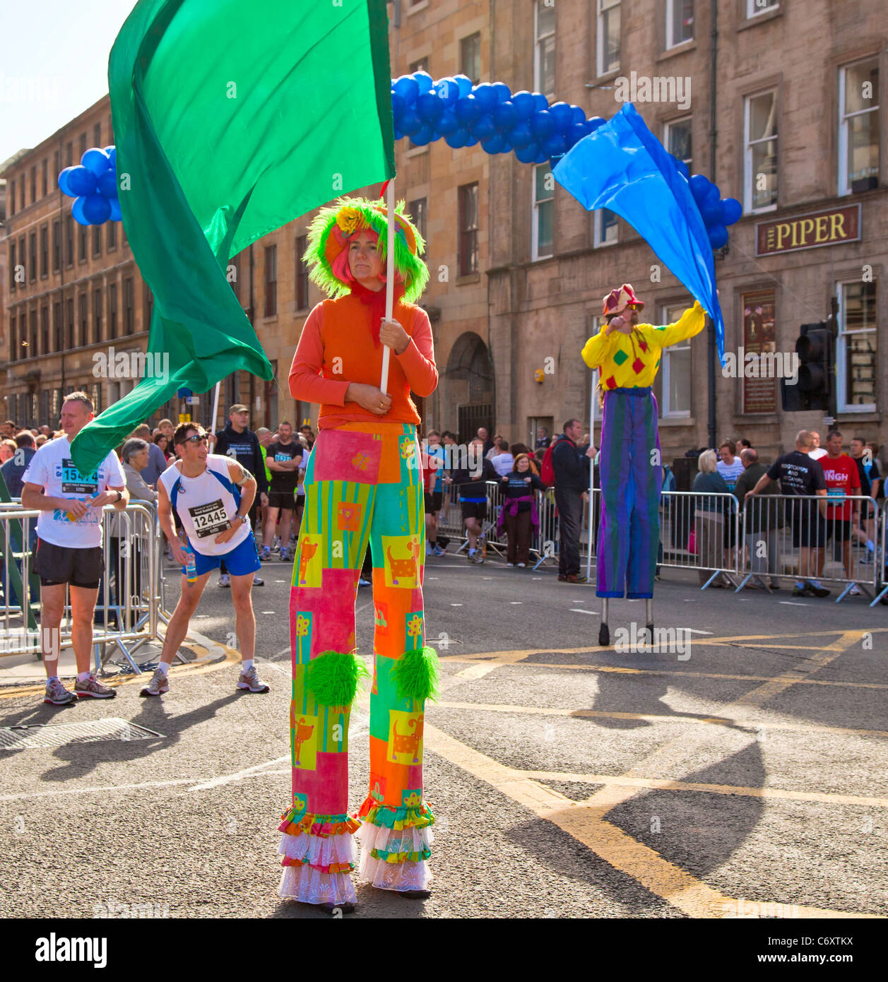 Stilt walkers guiding participants to their colourcoded start points