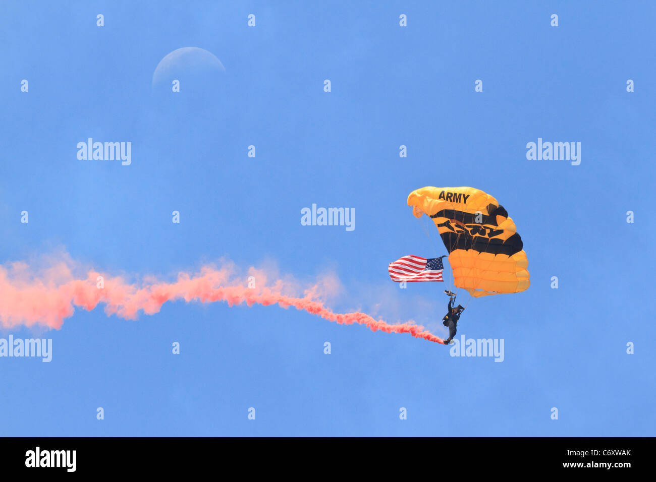 Army parachutist with smoke trail. Stock Photo