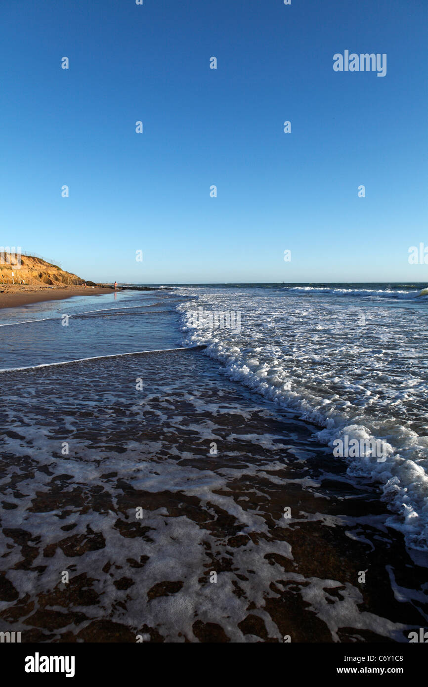 waves rushing in across the sand Stock Photo