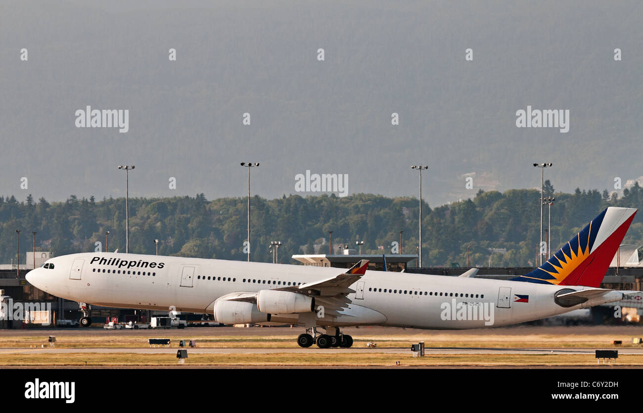 A Philippine Airlines Airbus A340 (A340-313X) jet airliner takes off from Vancouver International Airport. Stock Photo