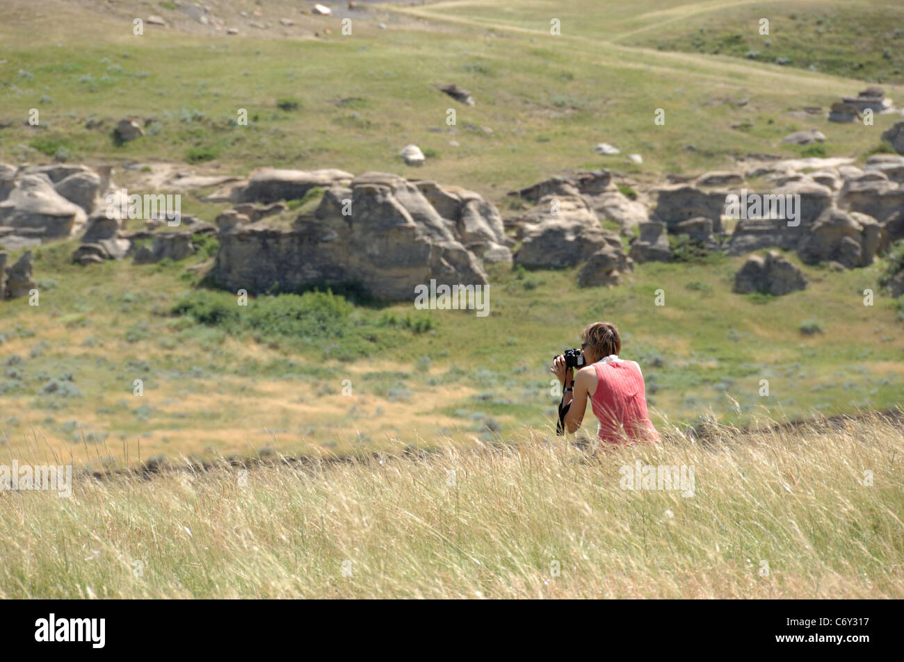 Woman taking pictures in Writing on Stone Provincial Park, Alberta, Canada. Stock Photo