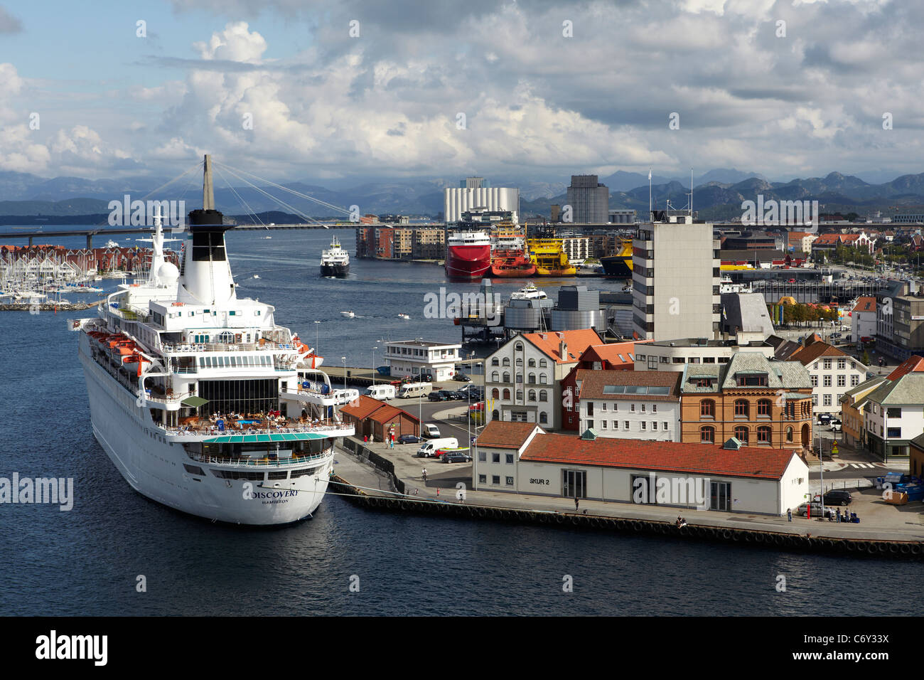 The cruise ship Discovery, moored at the Port of Stavanger, Norway, with anchor handling tugs in the background. Stock Photo