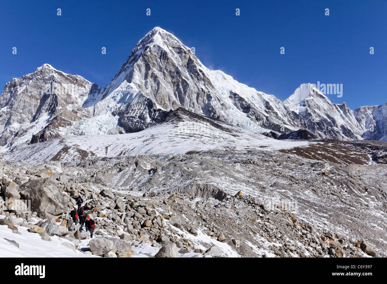 The domed Pumori mountain with the black rock of Kala Pathar in front