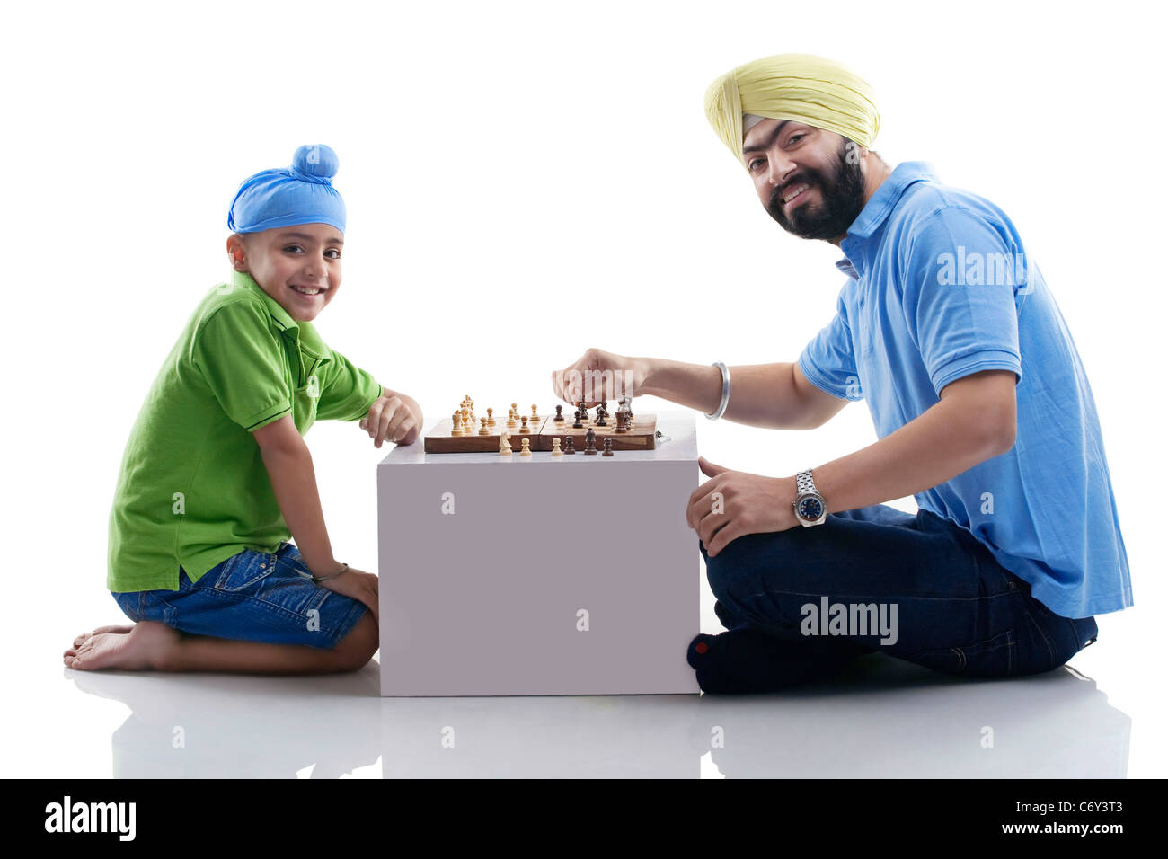 Sikh boy playing chess with his dad Stock Photo