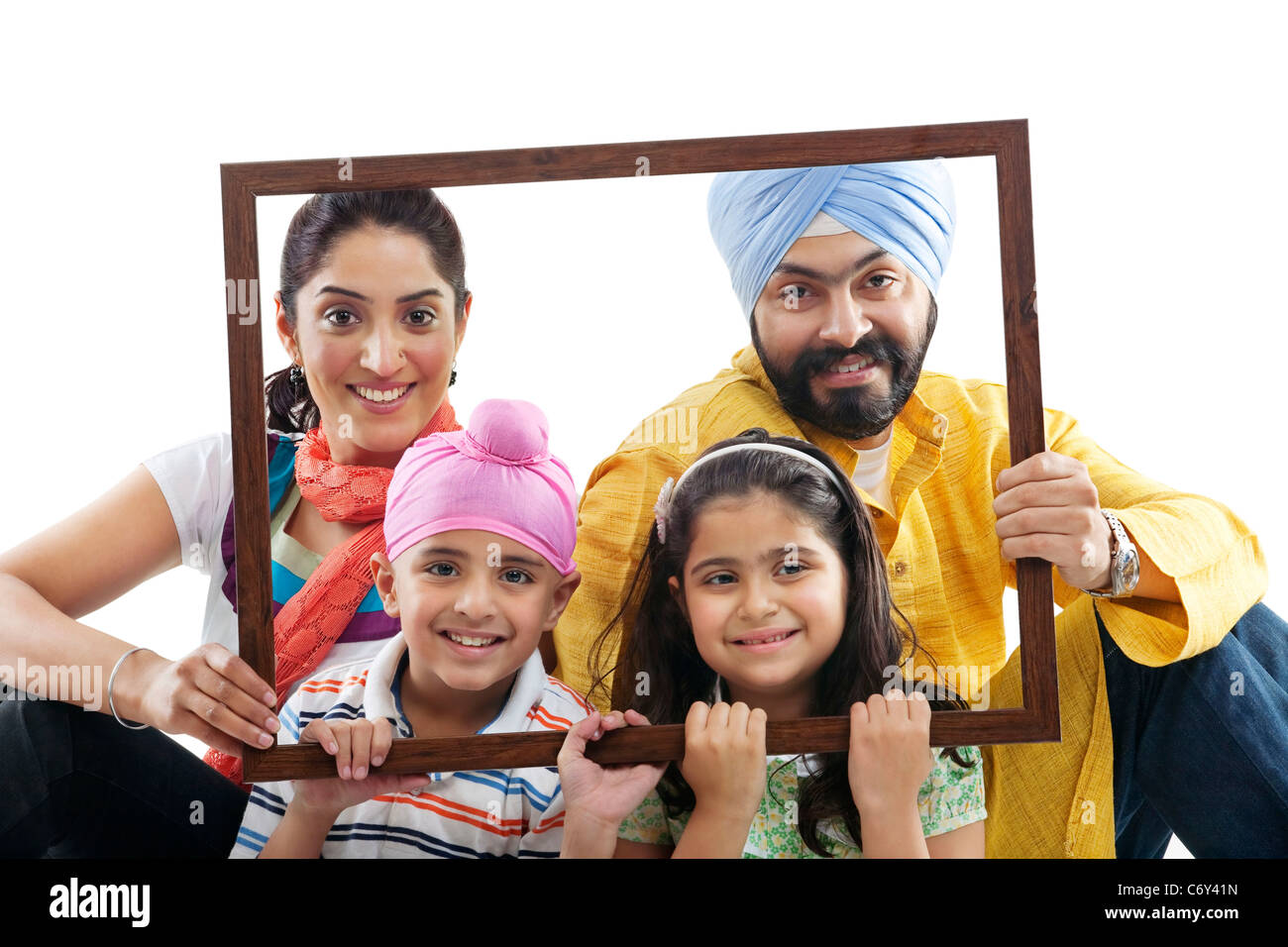 Portrait of a Sikh family through a wooden frame Stock Photo
