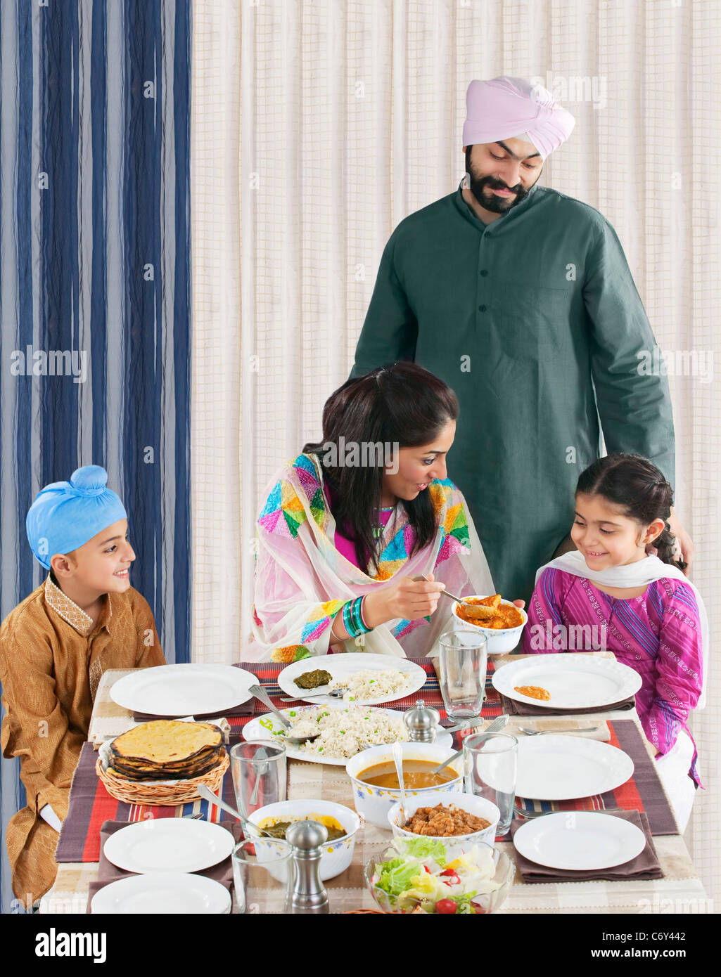 Mother serving her daughter some food Stock Photo
