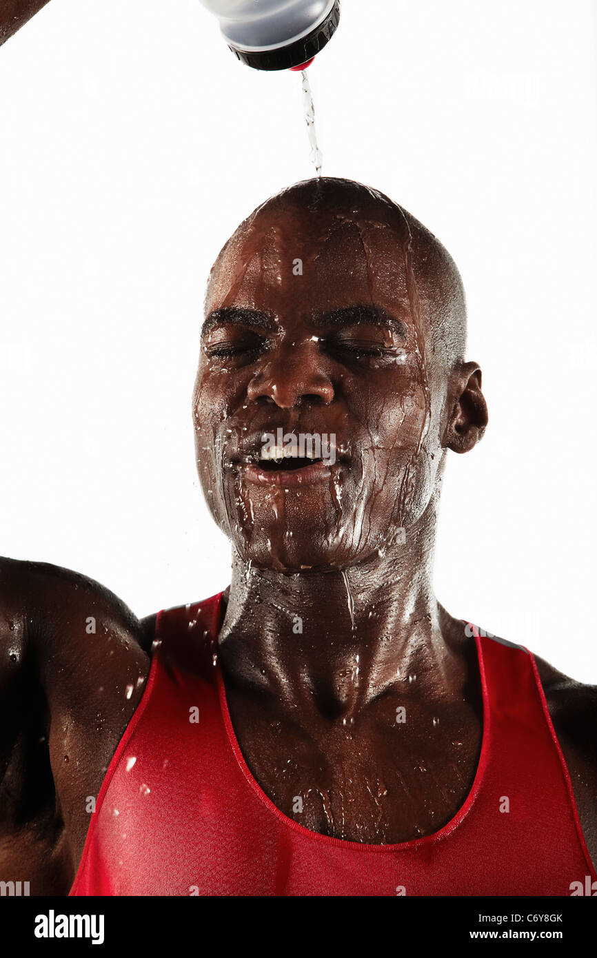 Athlete pouring water over his head Stock Photo Alamy