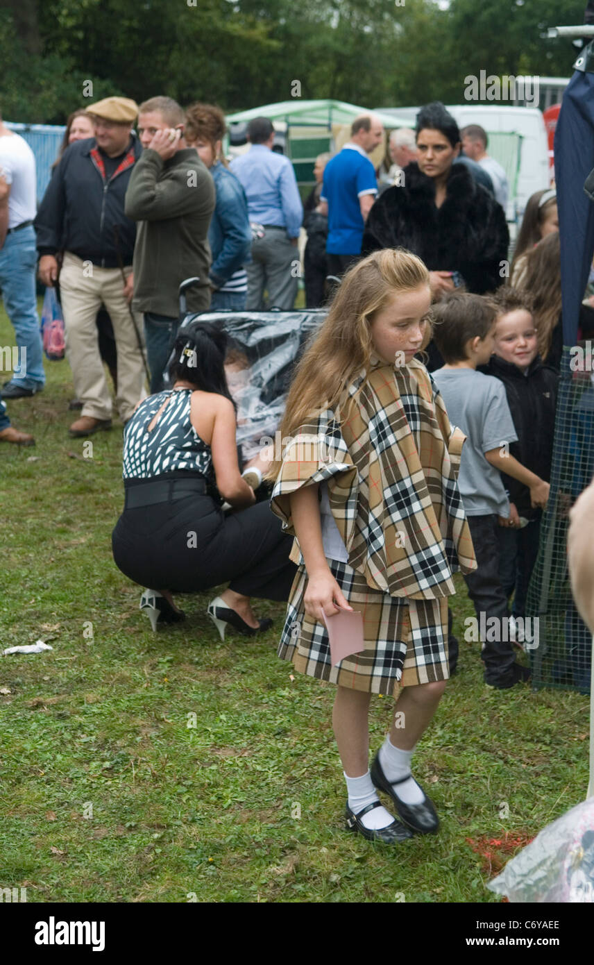 Chav gypsy Romany child wearing a classic Burberry style matching check cape and shirt Barnet Gypsy Horse Fair Hertfordshire UK. 2011 2010s HOMER SYKES Stock Photo