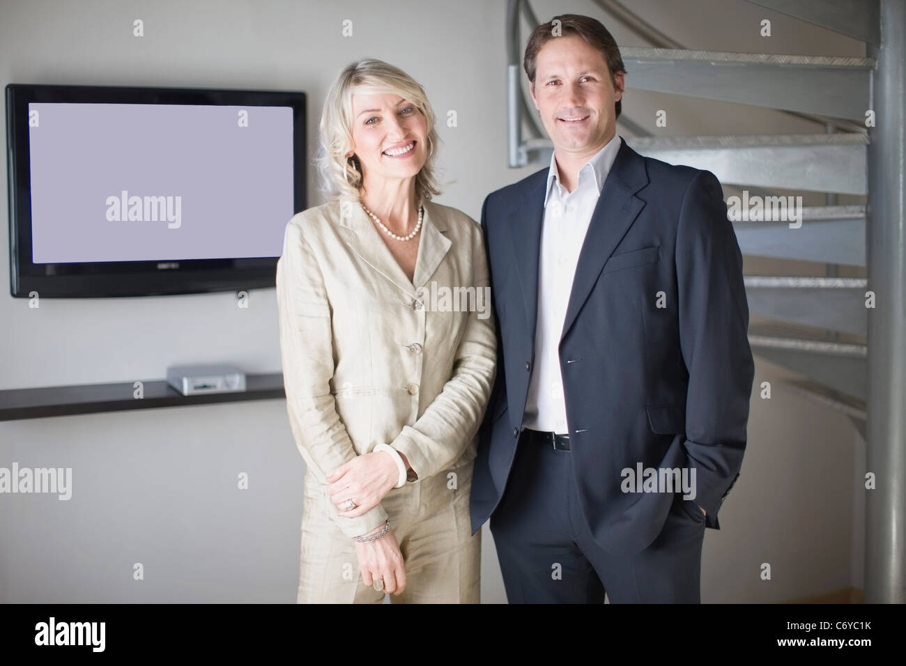 Business people smiling in office Stock Photo - Alamy