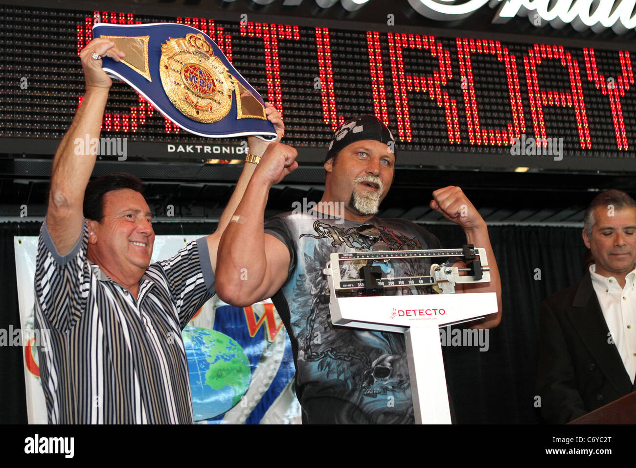 Francois Botha poses on the scale during the official weighin for his