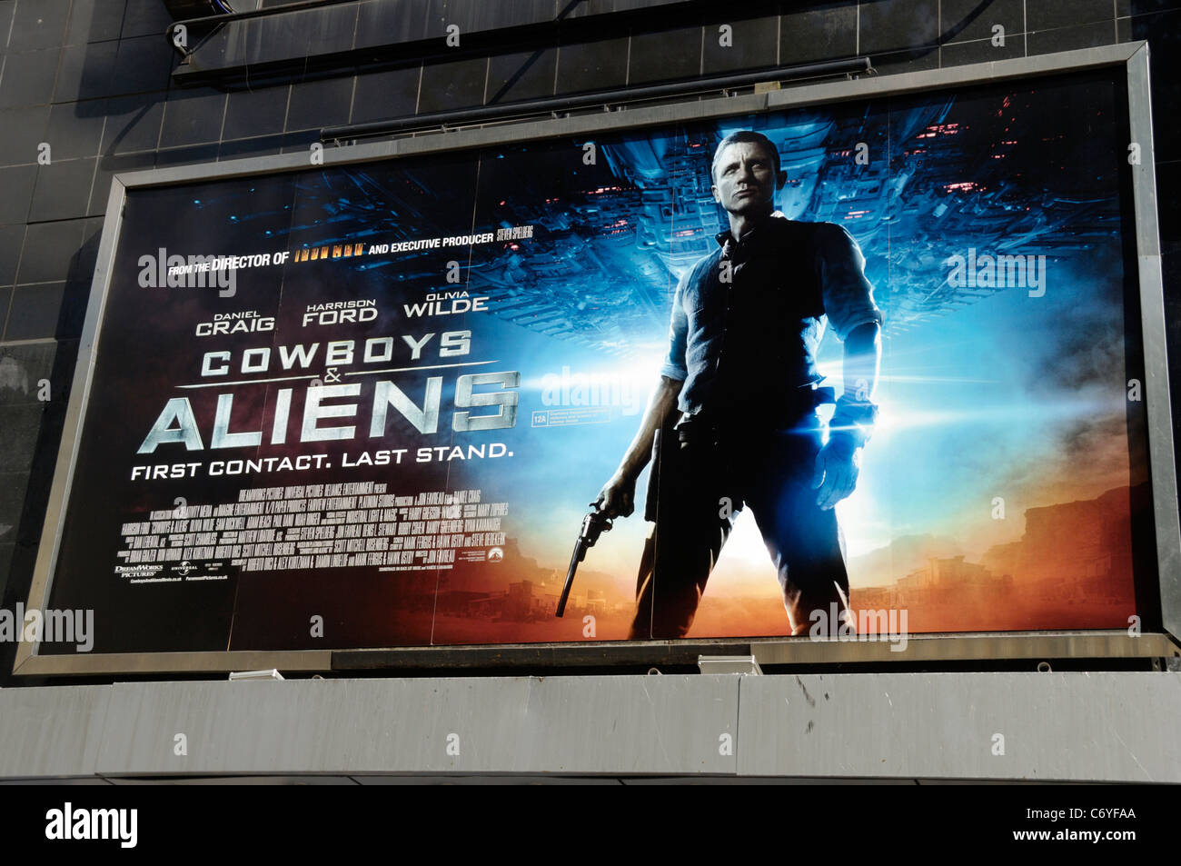 https://c8.alamy.com/comp/C6YFAA/billboard-promoting-the-movie-cowboys-and-aliens-C6YFAA.jpg