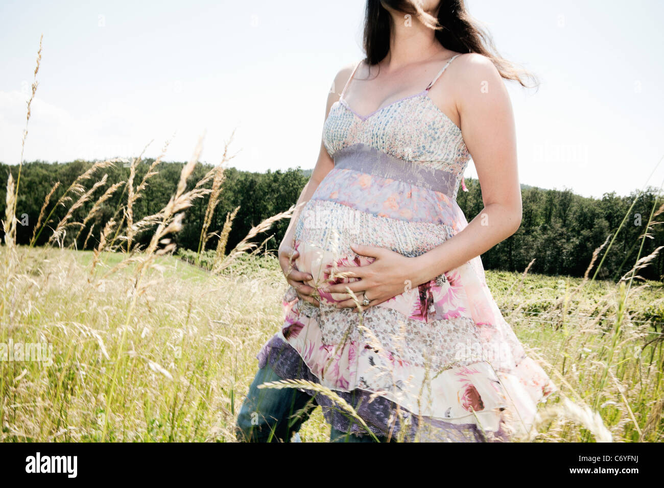 Pregnant woman holding her belly Stock Photo - Alamy