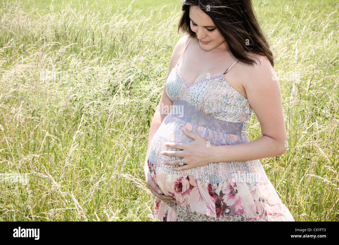 Pregnant woman holding her belly Stock Photo - Alamy