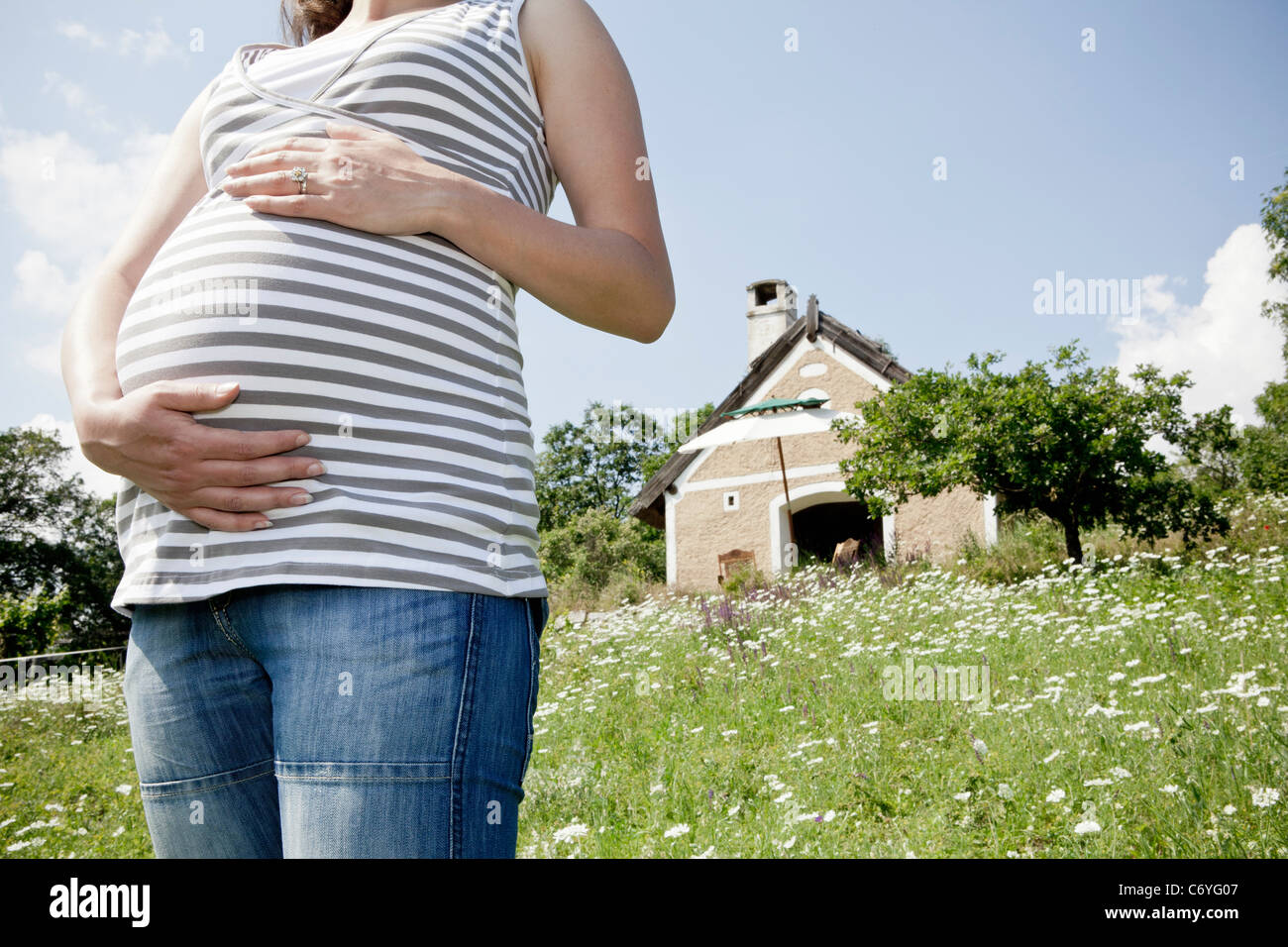 Pregnant woman holding her belly Stock Photo - Alamy