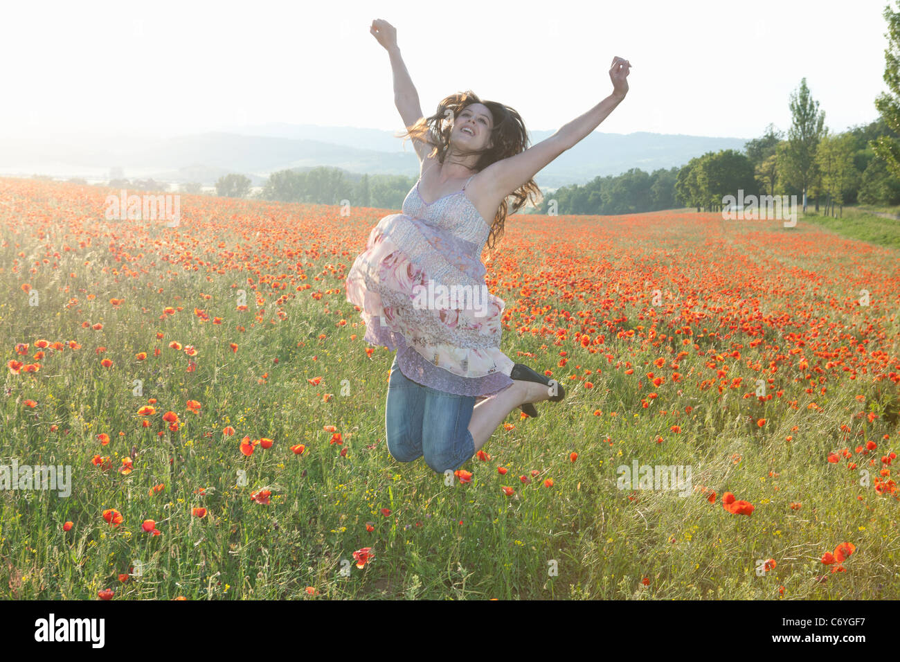 Pregnant woman in field of flowers Stock Photo Alamy