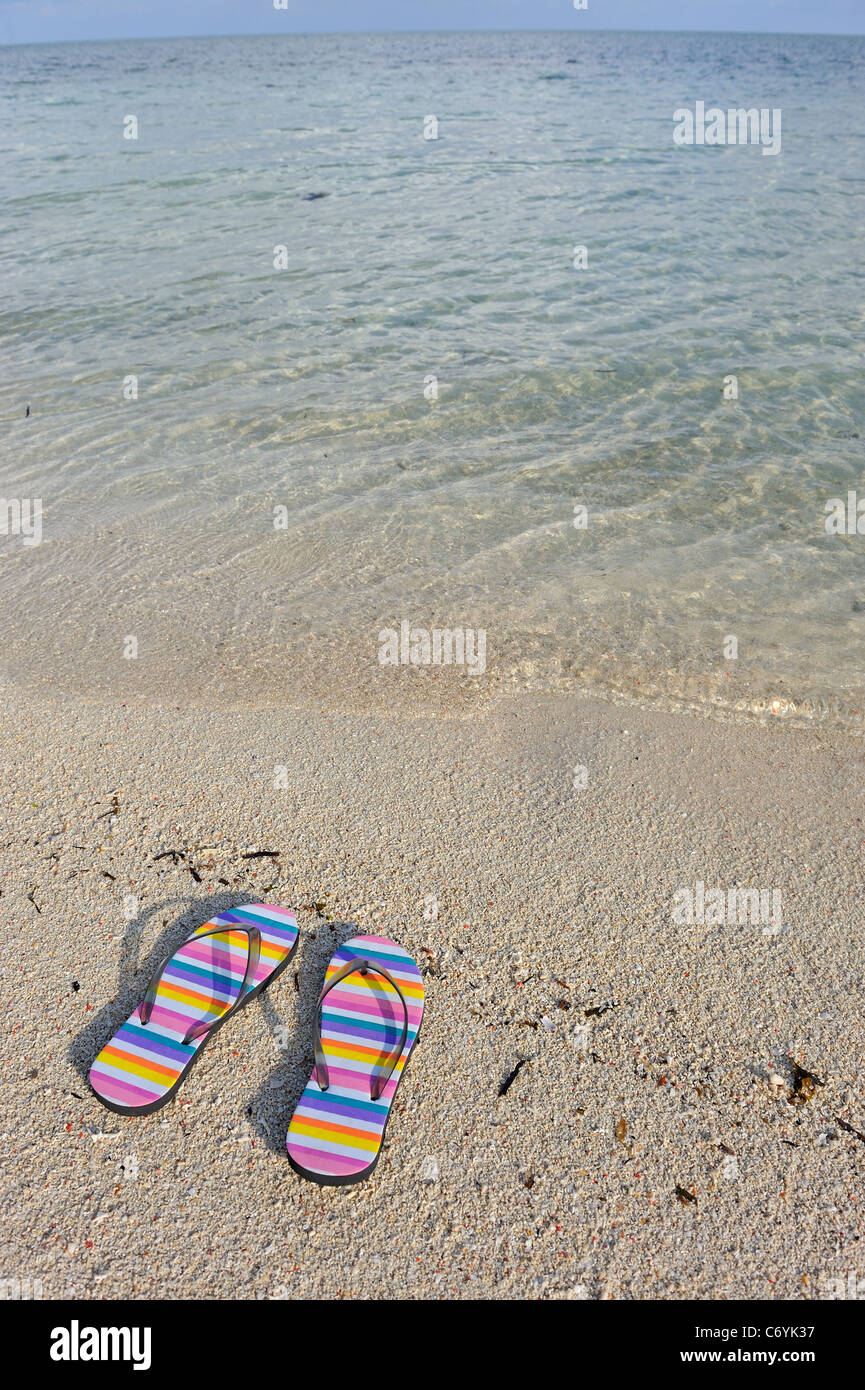 Flip flops on a beach Stock Photo
