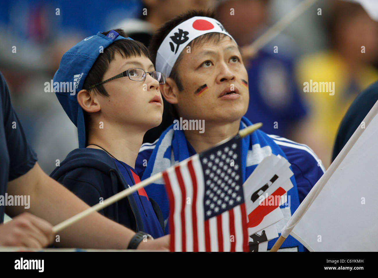 Young child and adult Japan supporters in the stands at the 2011 Women's World Cup final between the United States and Japan. Stock Photo
