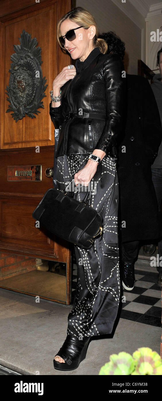 Madonna leaves an address in Chelsea after a private dinner wearing a tight fitting black leather jacket and dress printed with Stock Photo - Alamy Madonna leaves an address in Chelsea after a private dinner wearing a tight fitting black leather jacket and dress printed with Stock Photo - Alamy