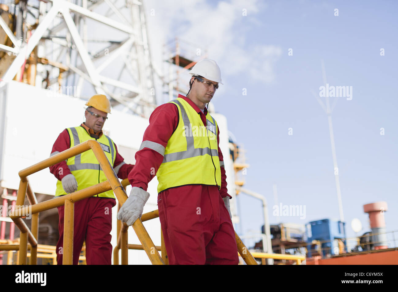 Workers walking on oil rig Stock Photo Alamy