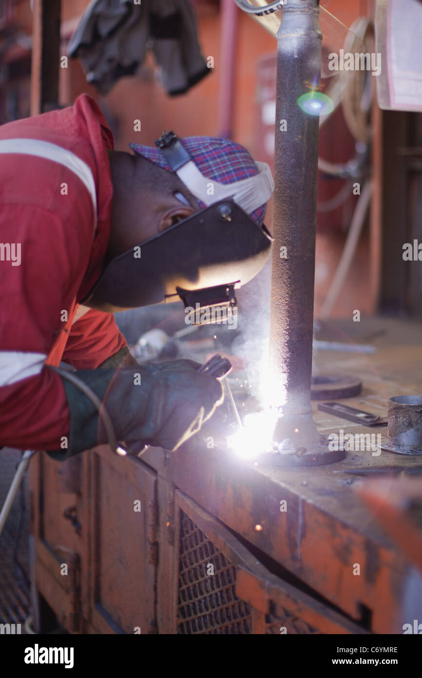 Worker welding on oil rig Stock Photo Alamy