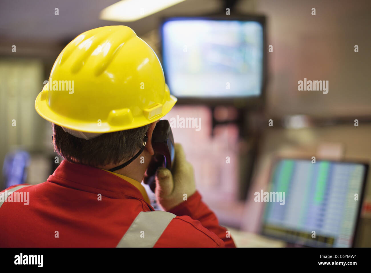 Worker watching security cameras Stock Photo