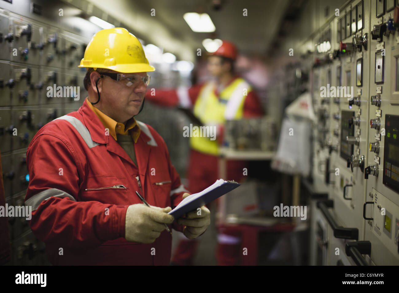 Worker checking machinery Stock Photo
