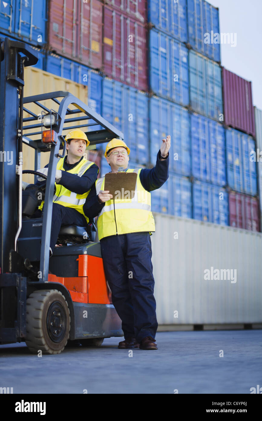 Workers talking in shipping yard Stock Photo