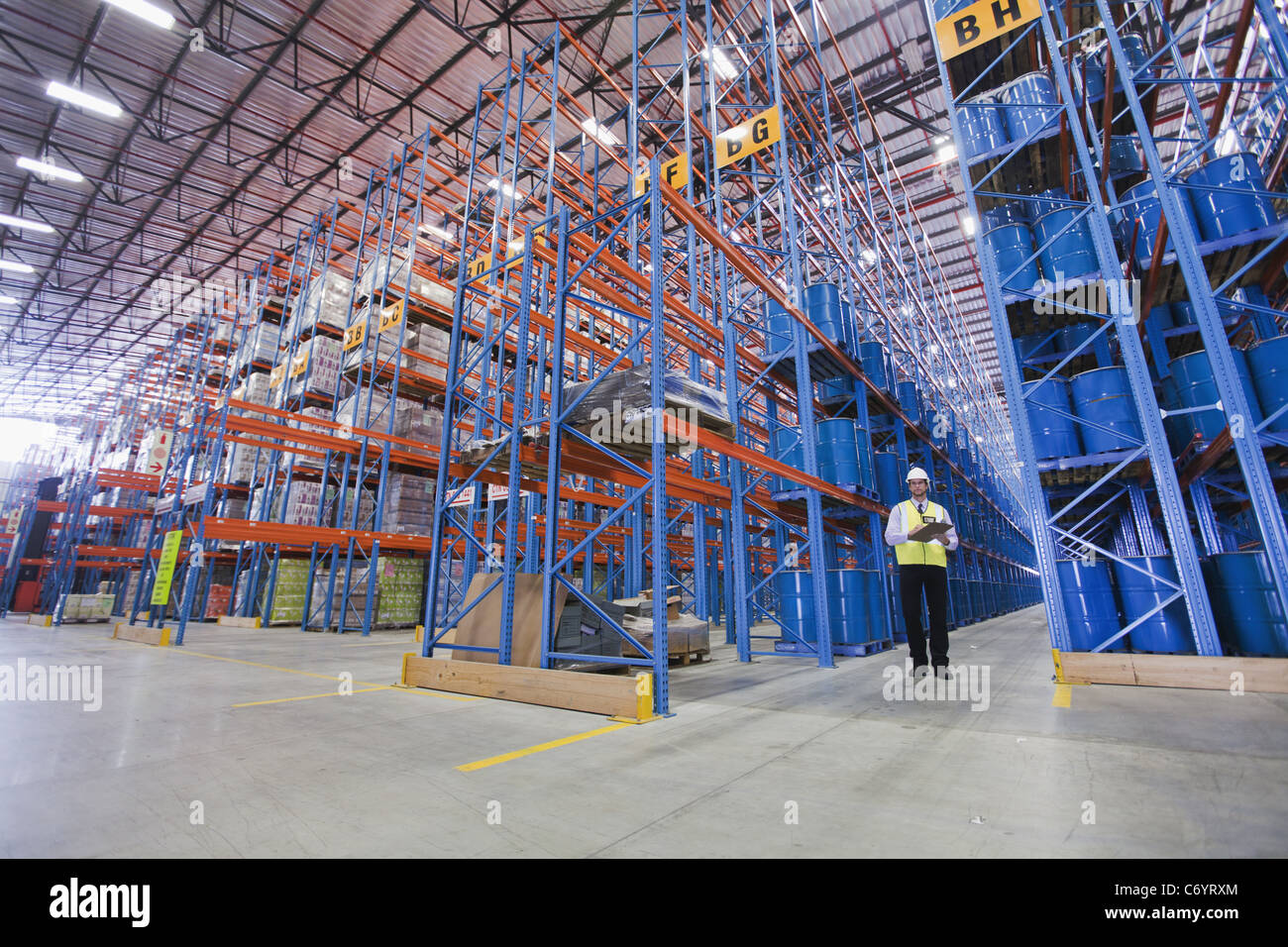 Worker standing in warehouse Stock Photo Alamy