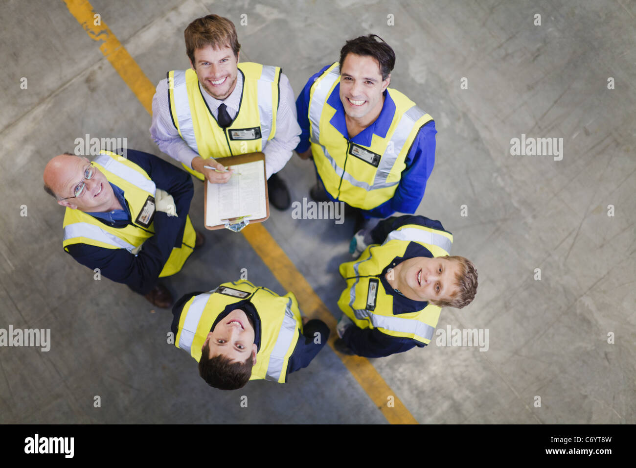 Workers talking in warehouse Stock Photo - Alamy