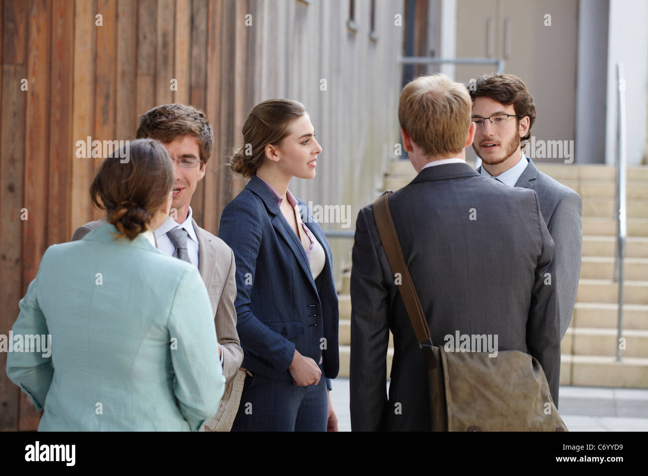 Business people talking in courtyard Stock Photo