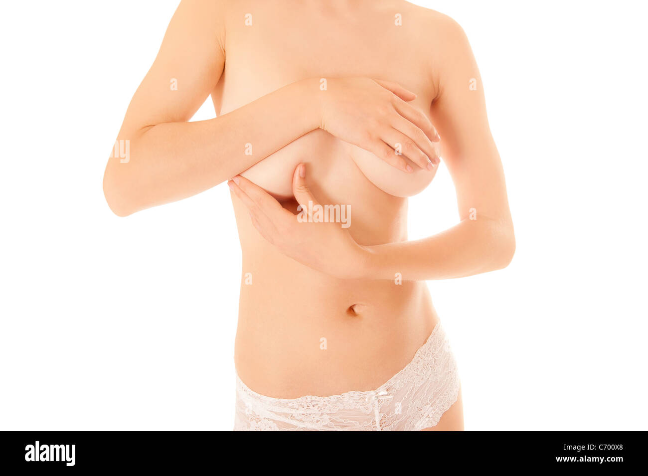 Beautiful young woman in white panties examining her breasts for lumps or  signs of breast cancer, isolated on white Stock Photo - Alamy