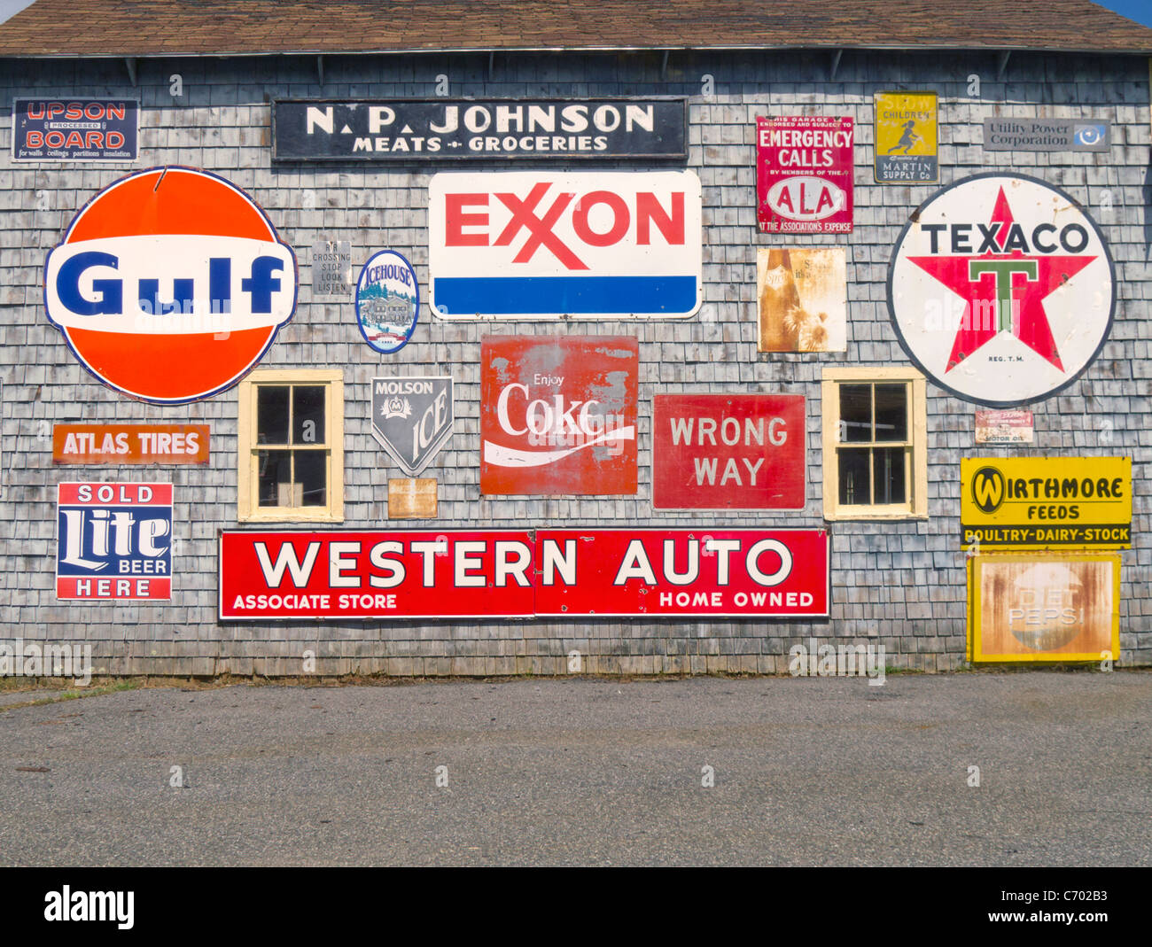 Barn with old gas station signs Stock Photo
