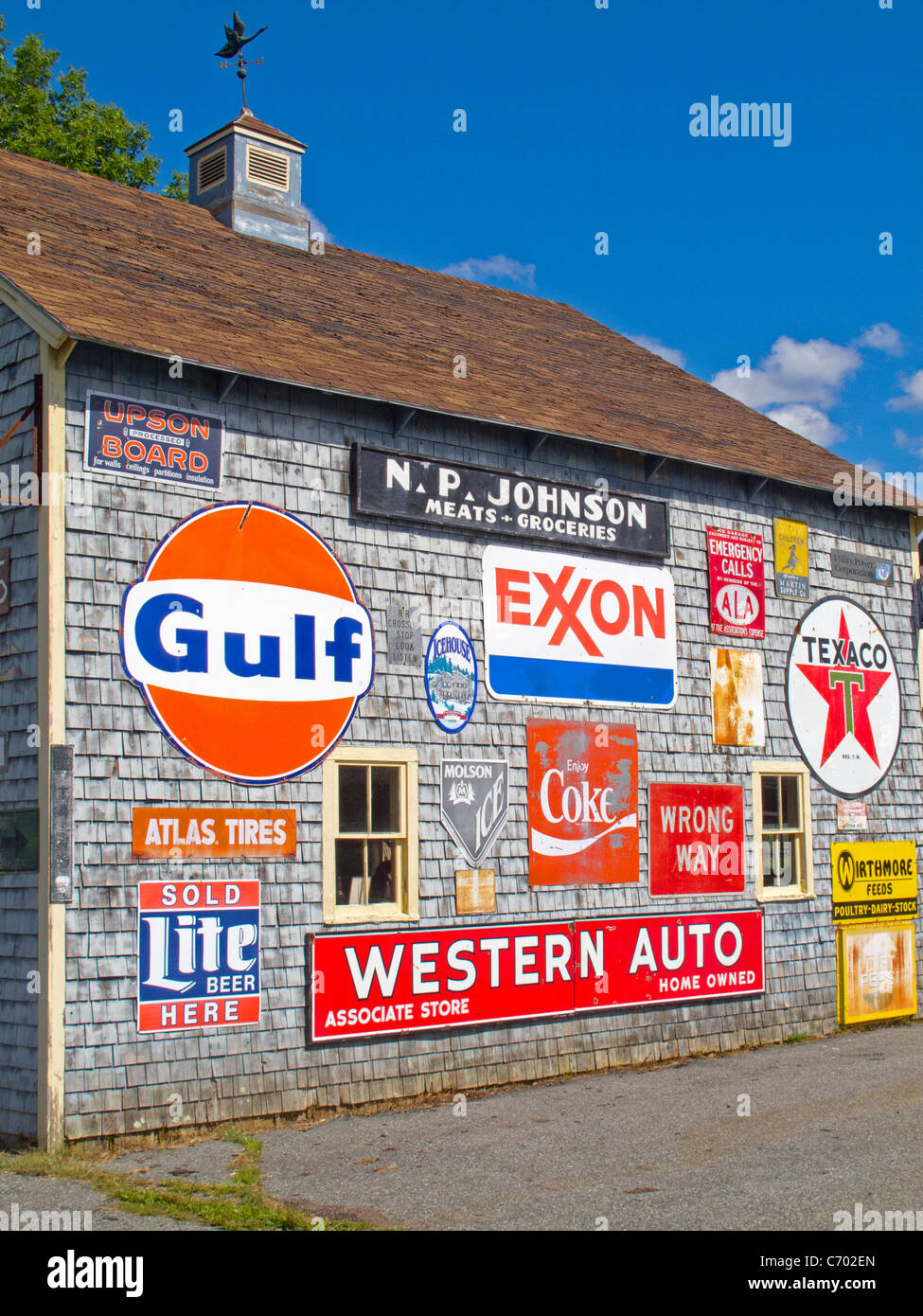 Barn with old gas station signs Stock Photo