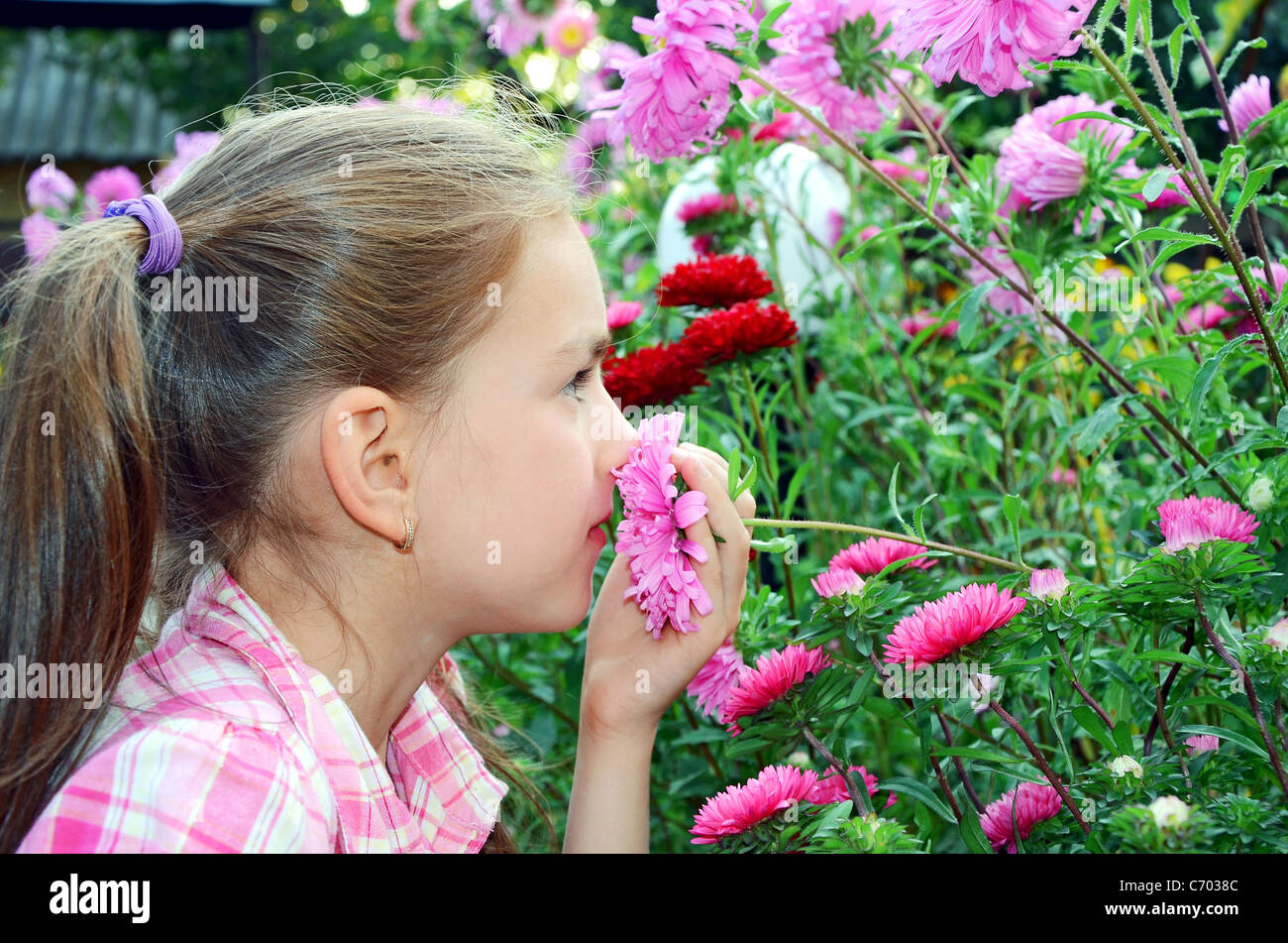 a girl smelling flowers Stock Photo - Alamy