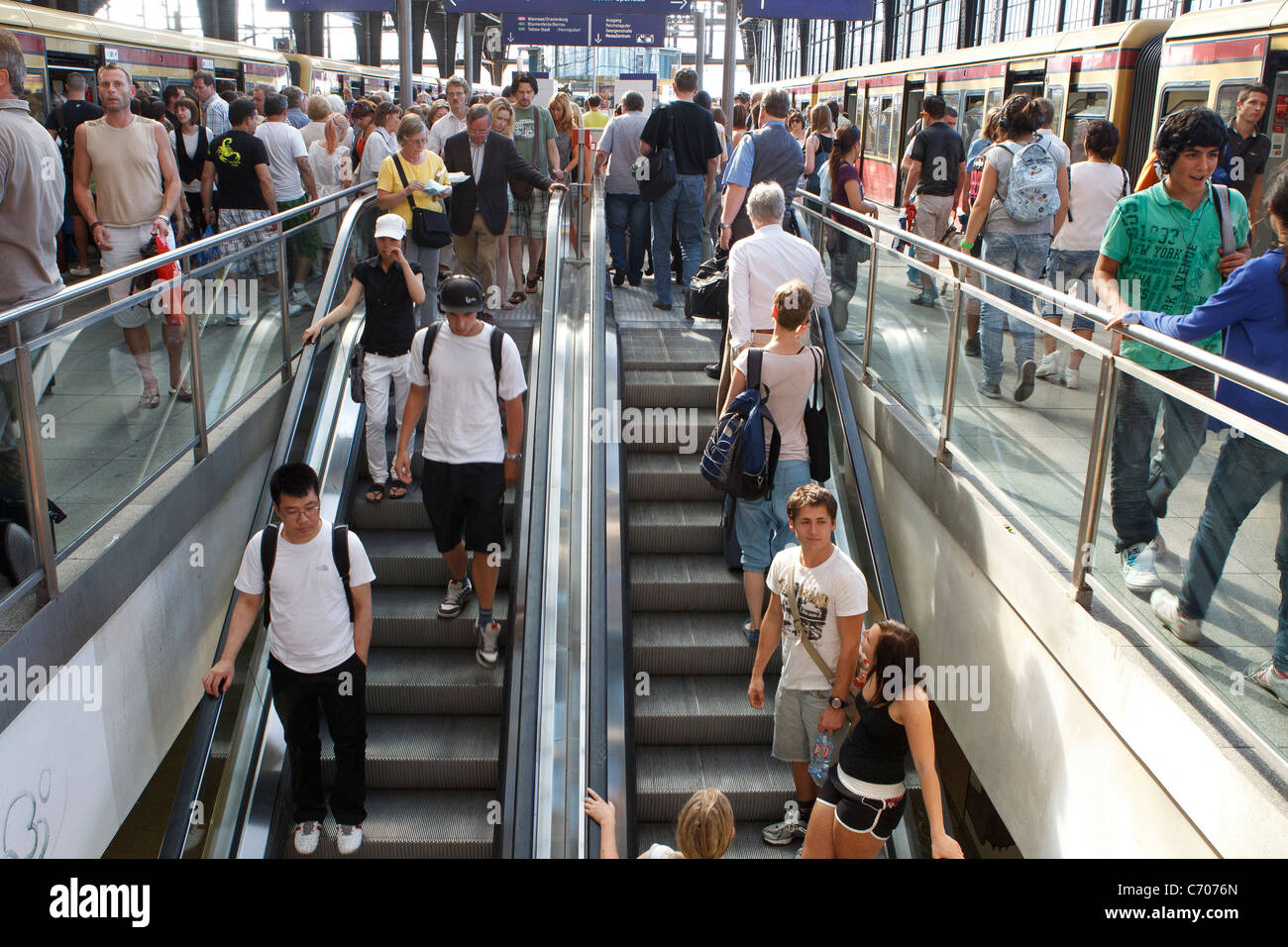 large group crowd people train station escalator platform busy commuters commuting Stock Photo