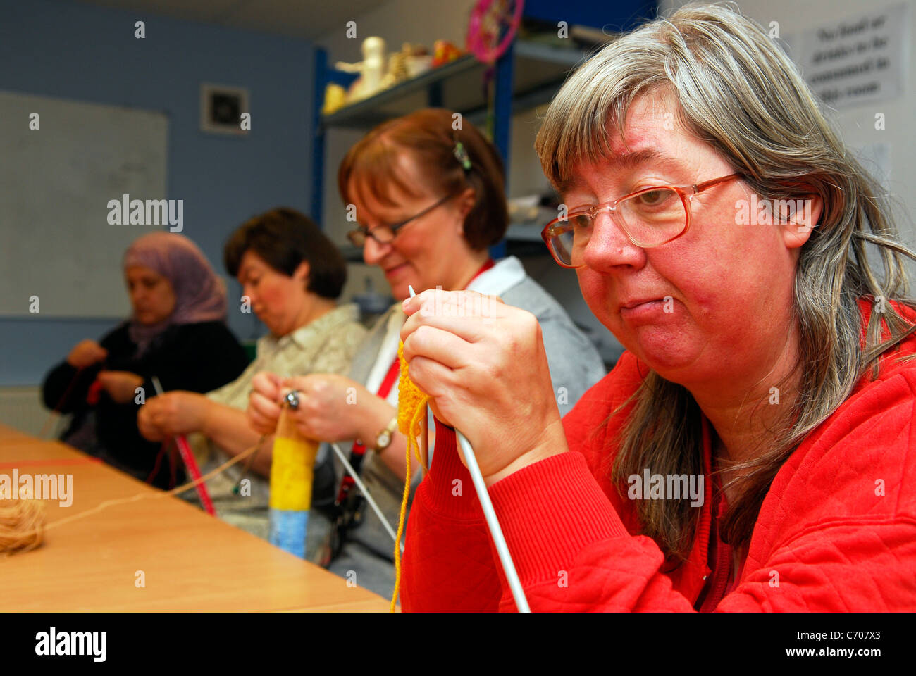 Women taking part in a knitting class for people with physical and learning difficulties, Grimsby, Lincolnshire, UK. Stock Photo
