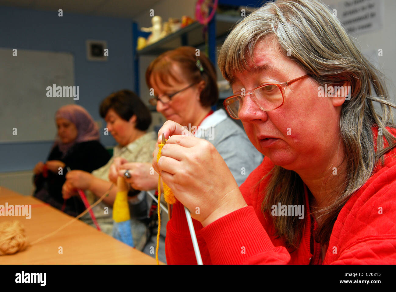 Women taking part in a knitting class for people with physical and learning difficulties, Grimsby, Lincolnshire, UK. Stock Photo