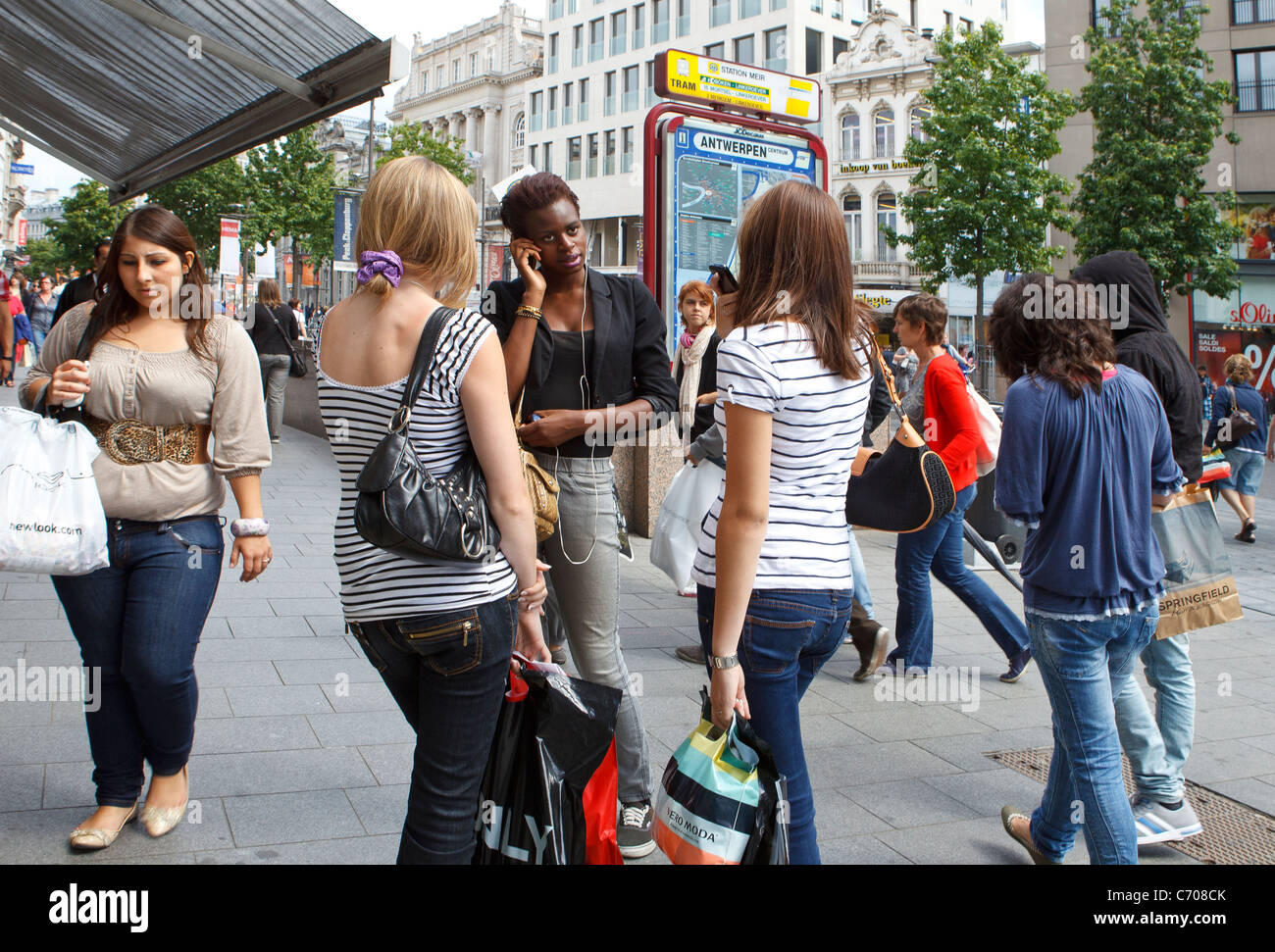 group gang crowd young people talking street girls women shopping black white african american caucasian mixed race teen teens Stock Photo