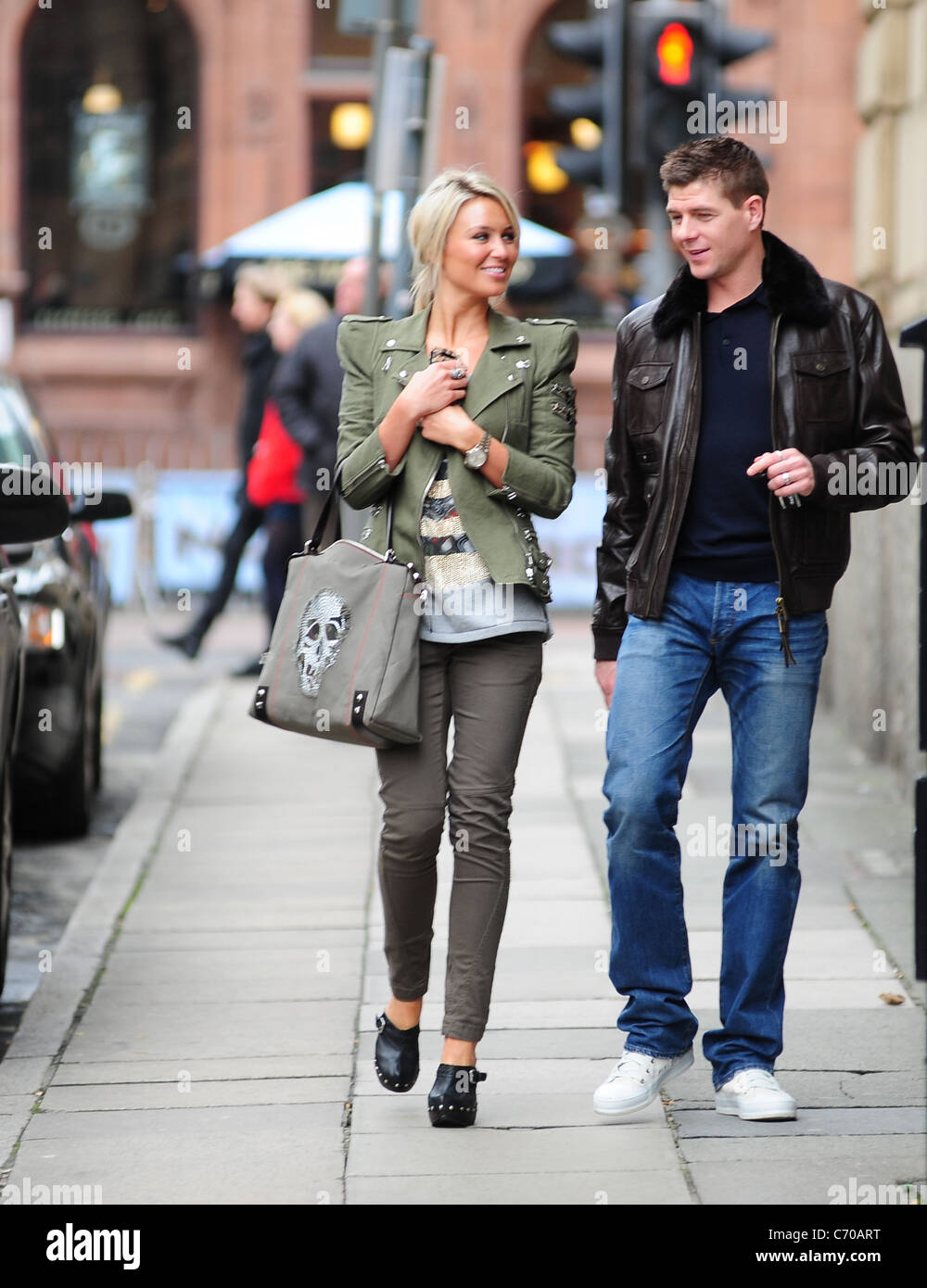 Steven Gerrard and Alex Curran return to their vehicle after the Liverpool  footballer's Jaguar car was parked illegally and Stock Photo - Alamy